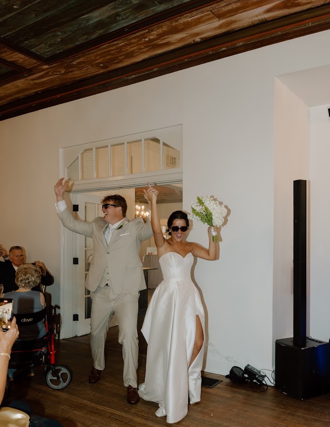 The couple celebrating their entrance to the wedding reception