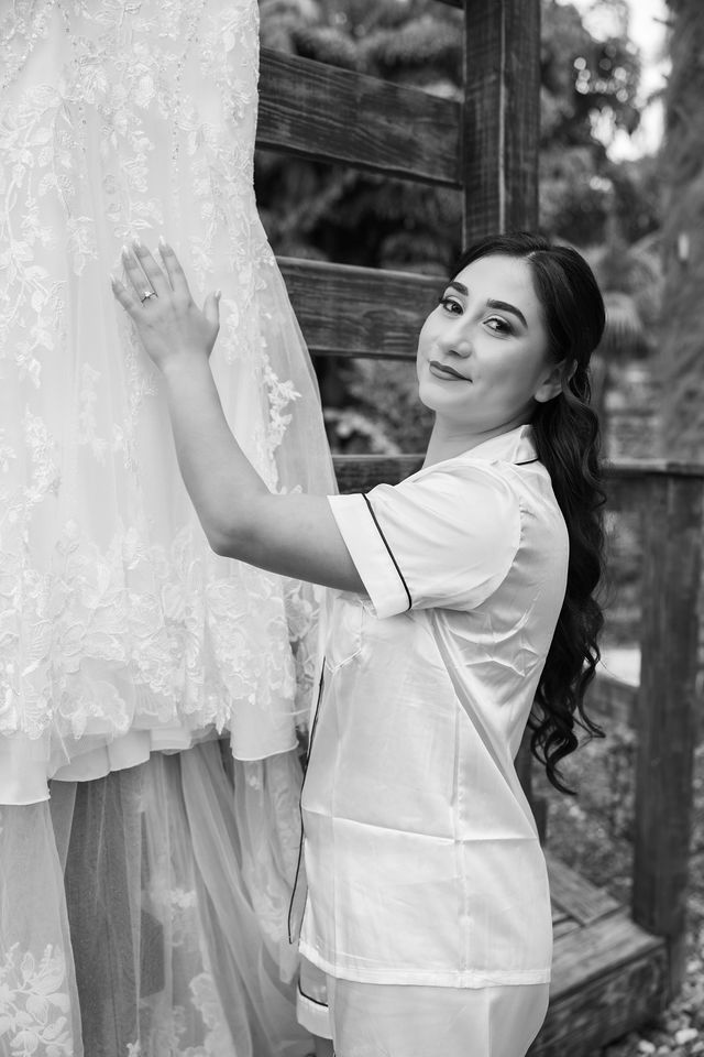 The bride beside her lace wedding dress before the celebration