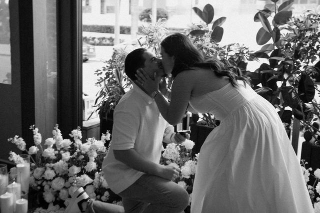 A black-and-white kiss after the proposal