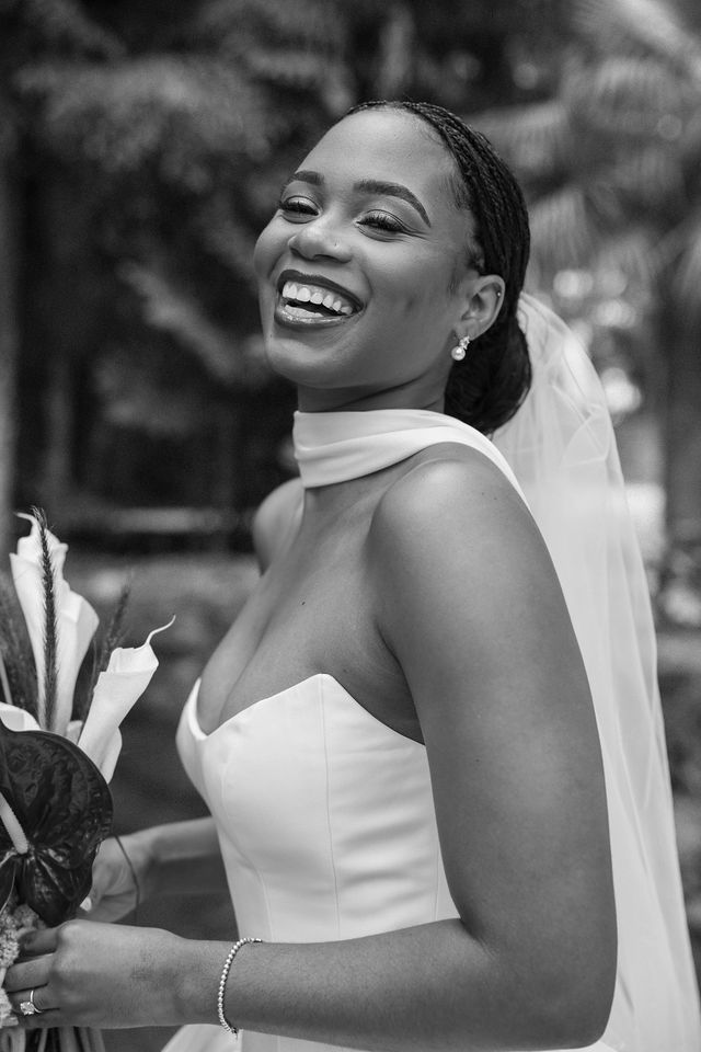 A smiling bride in a black-and-white portrait