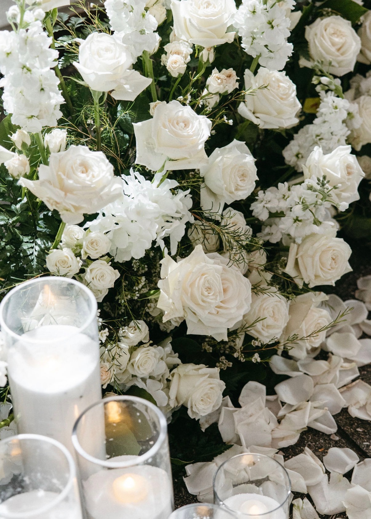 White roses and candlelight in close-up