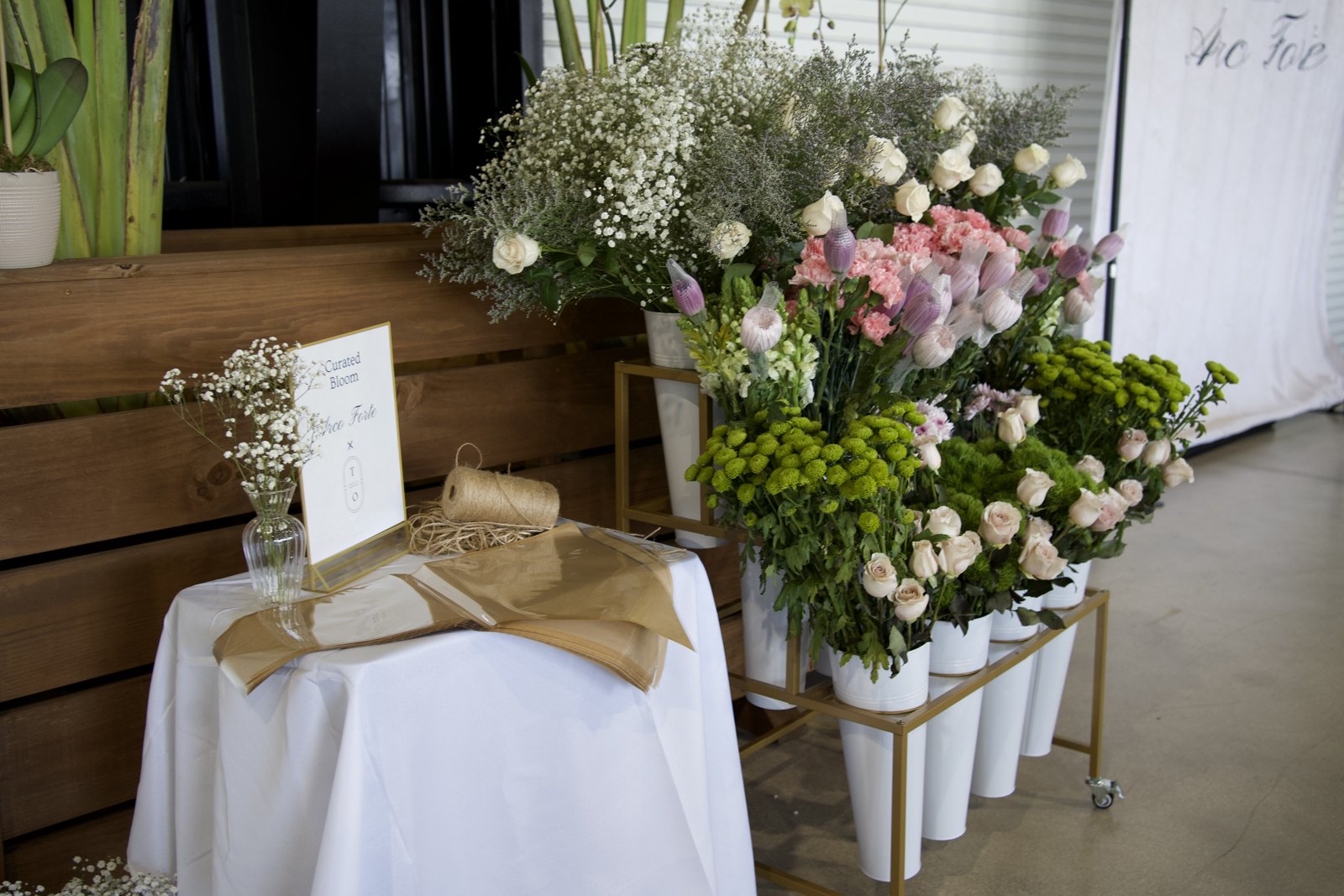 A fresh flower bar with colorful blooms and bouquet wrapping
