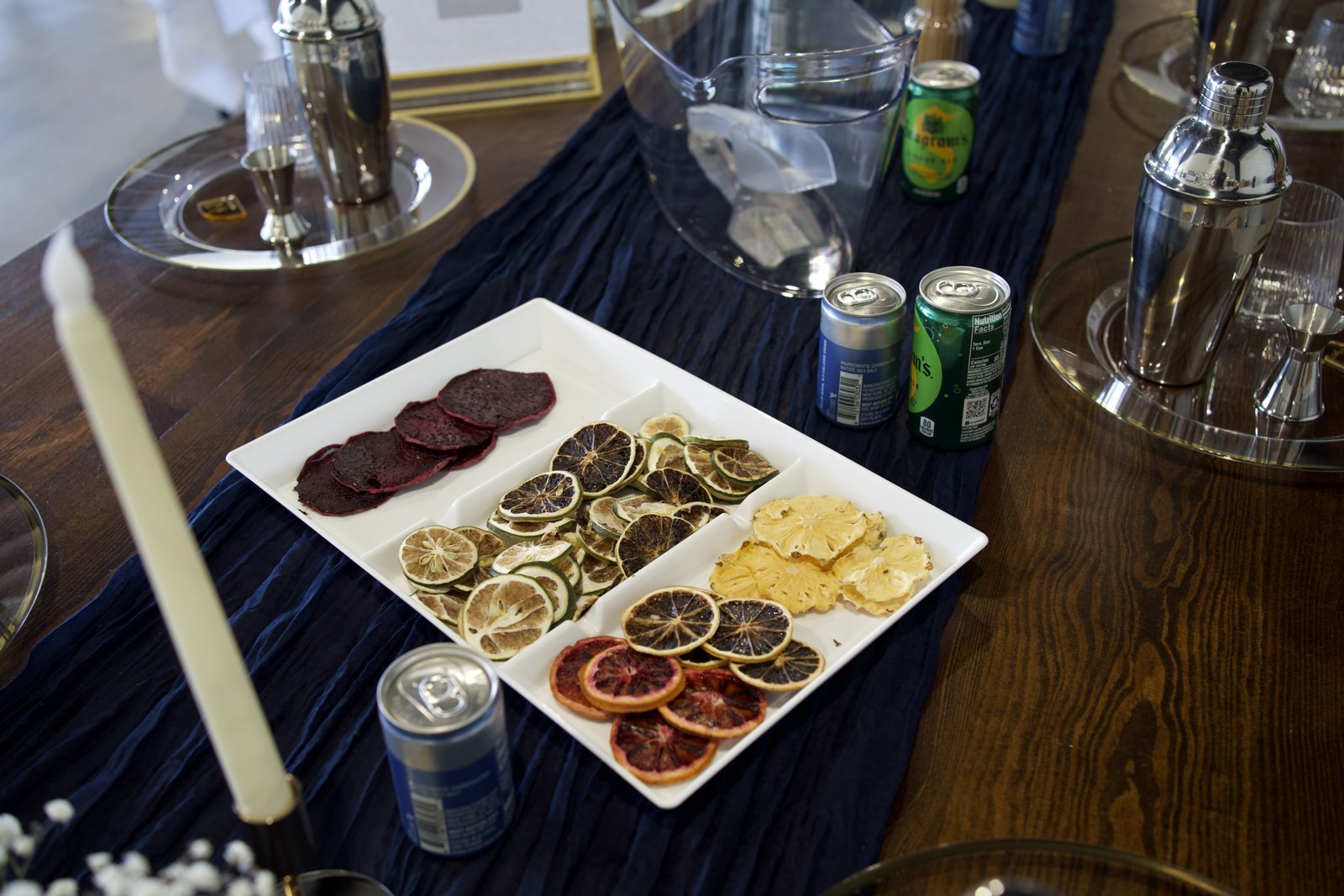 Cocktail shakers and dried citrus arranged for an interactive drink experience